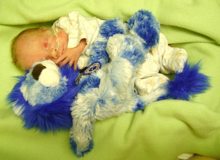 Baby Jacob snuggles with his Ryan's Lion